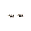 Camera-shaped cufflinks on a white background