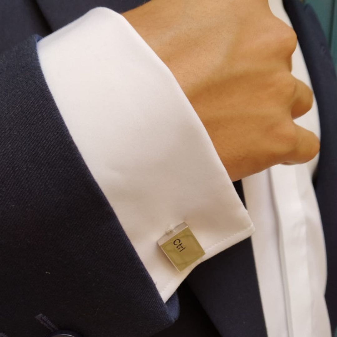 Close-up of a Ctrl cufflink on a suit sleeve 