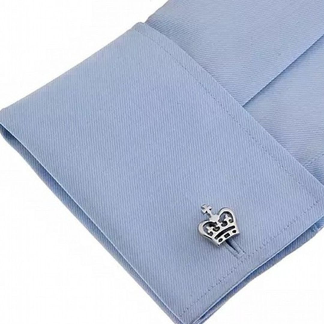 Crown-shaped cufflink on a light blue shirt