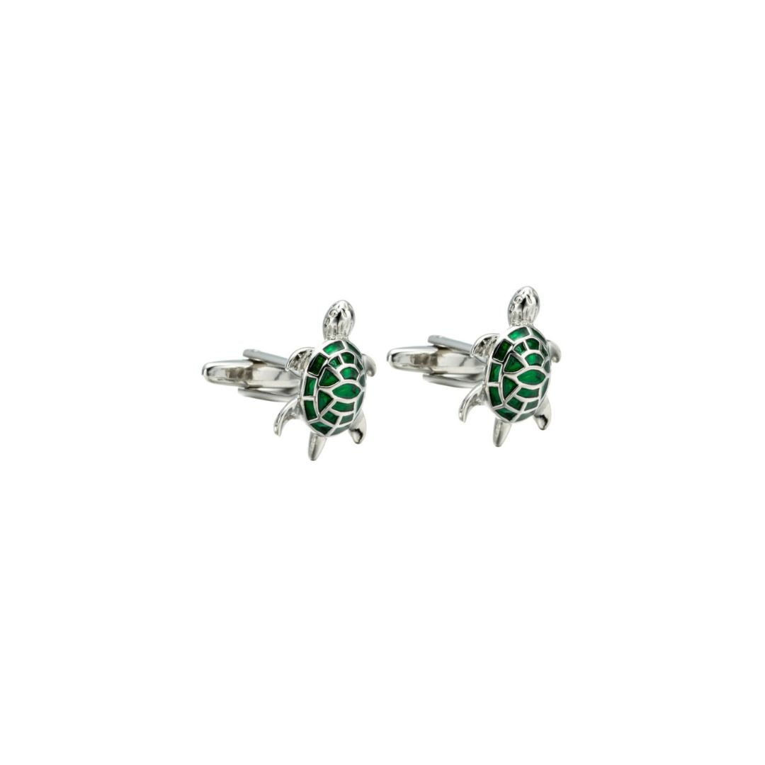 Turtle-shaped cufflinks with green details on a white background