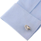 Grenade-shaped cufflink on a light blue shirt