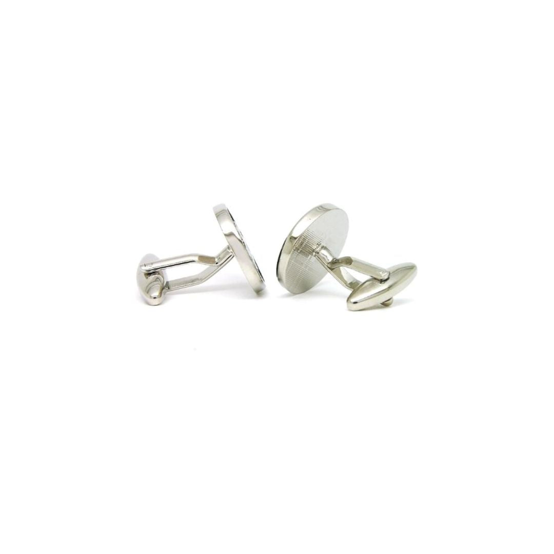 Pair of silver cufflinks on a white background