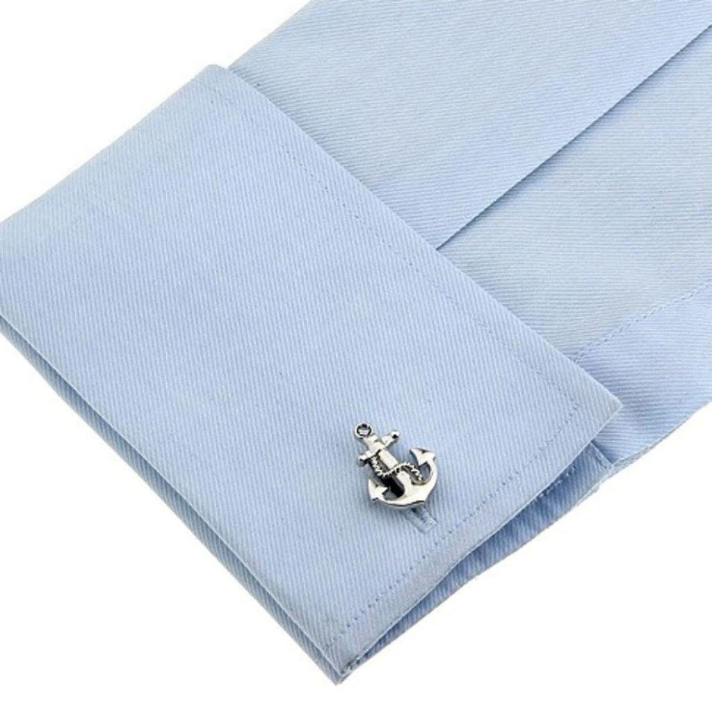 Silver anchor cufflink on a light blue pocket square