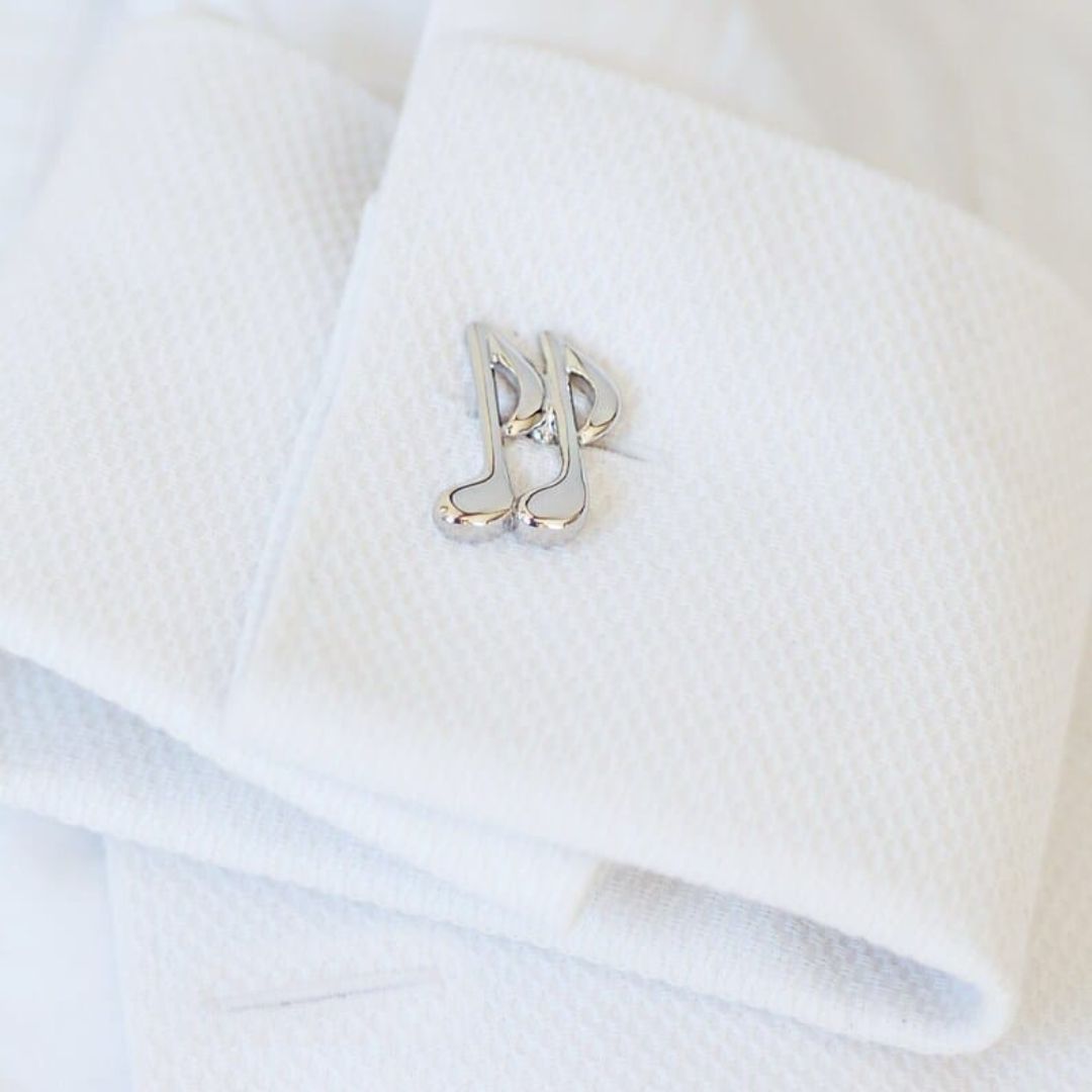 Silver music notes on a white shirt