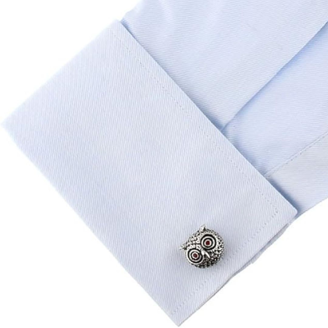 Silver owl cufflink on a light blue shirt