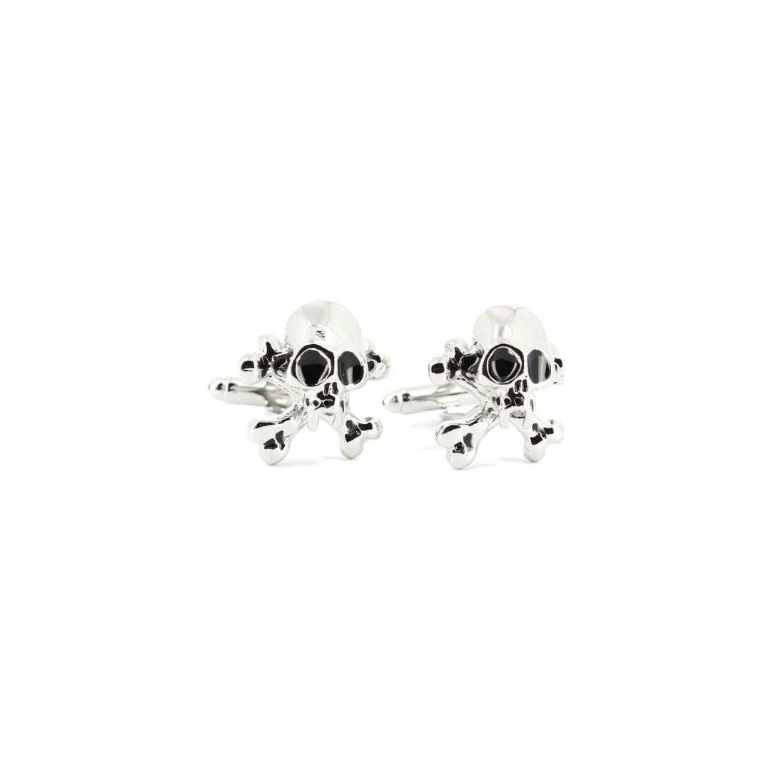 Silver skull cufflinks with black eye sockets on a white background