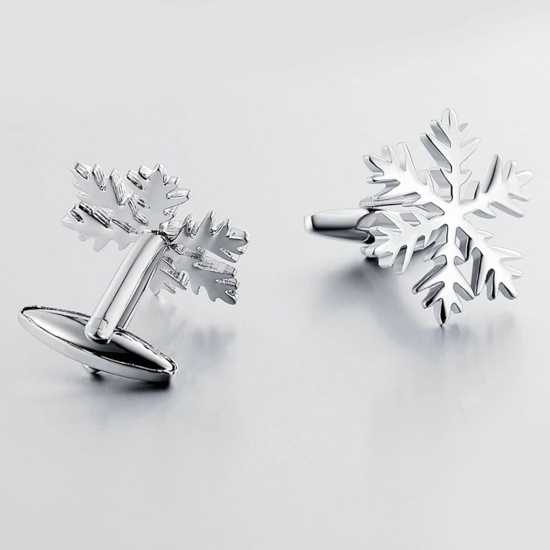 Silver snowflake cufflinks on a light grey background