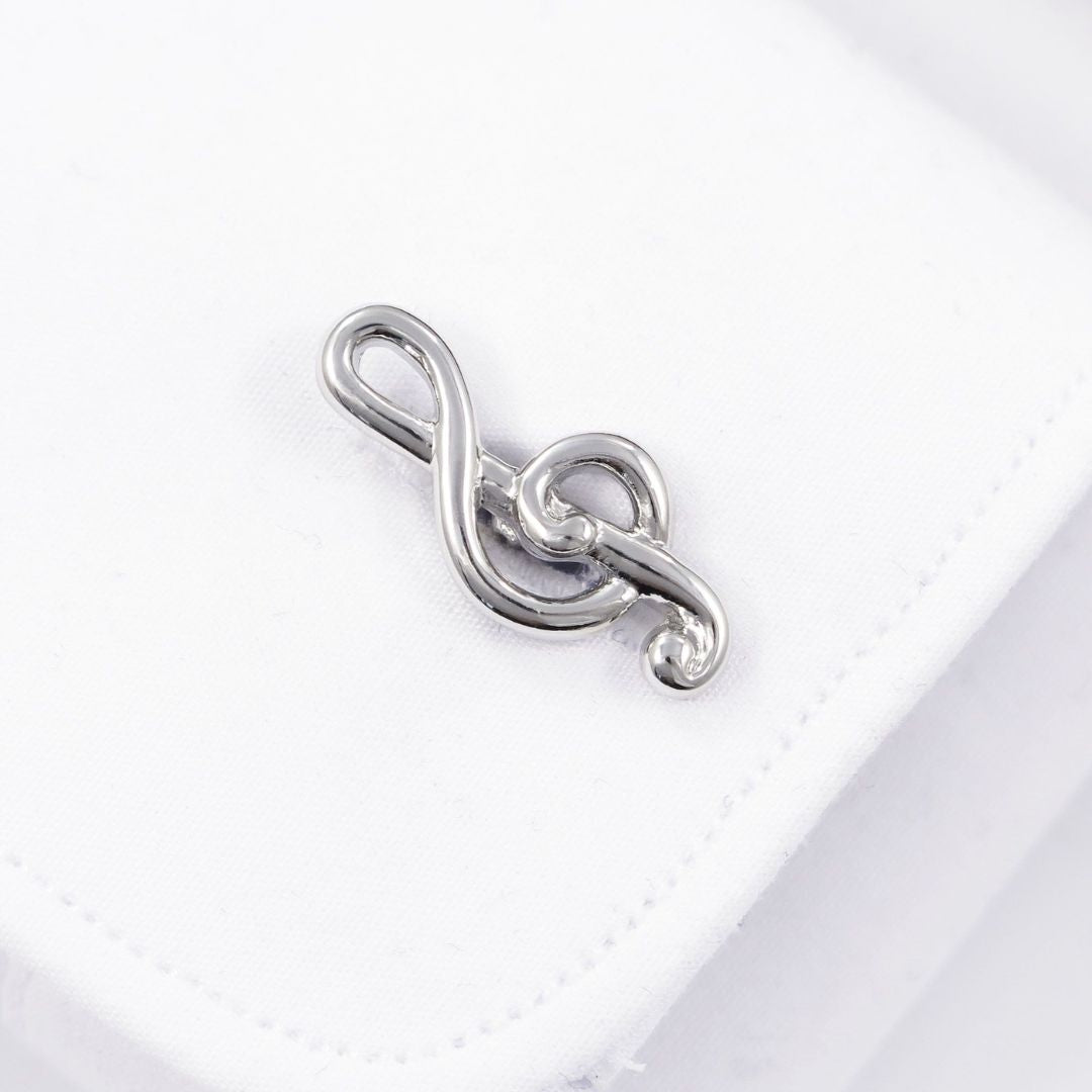 Silver treble clef charm on a white background
