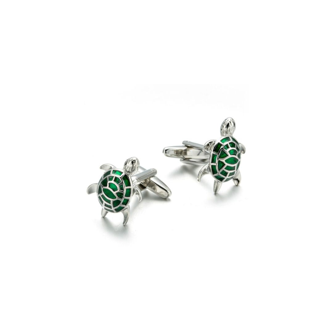 Turtle-shaped cufflinks with green details on a white background