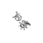 Two silver cufflinks with an anchor and steering wheel design on a white background