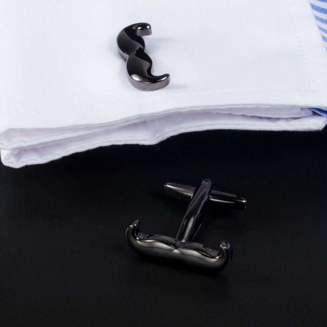 black Mustache-shaped cufflinks on a white shirt with a black background